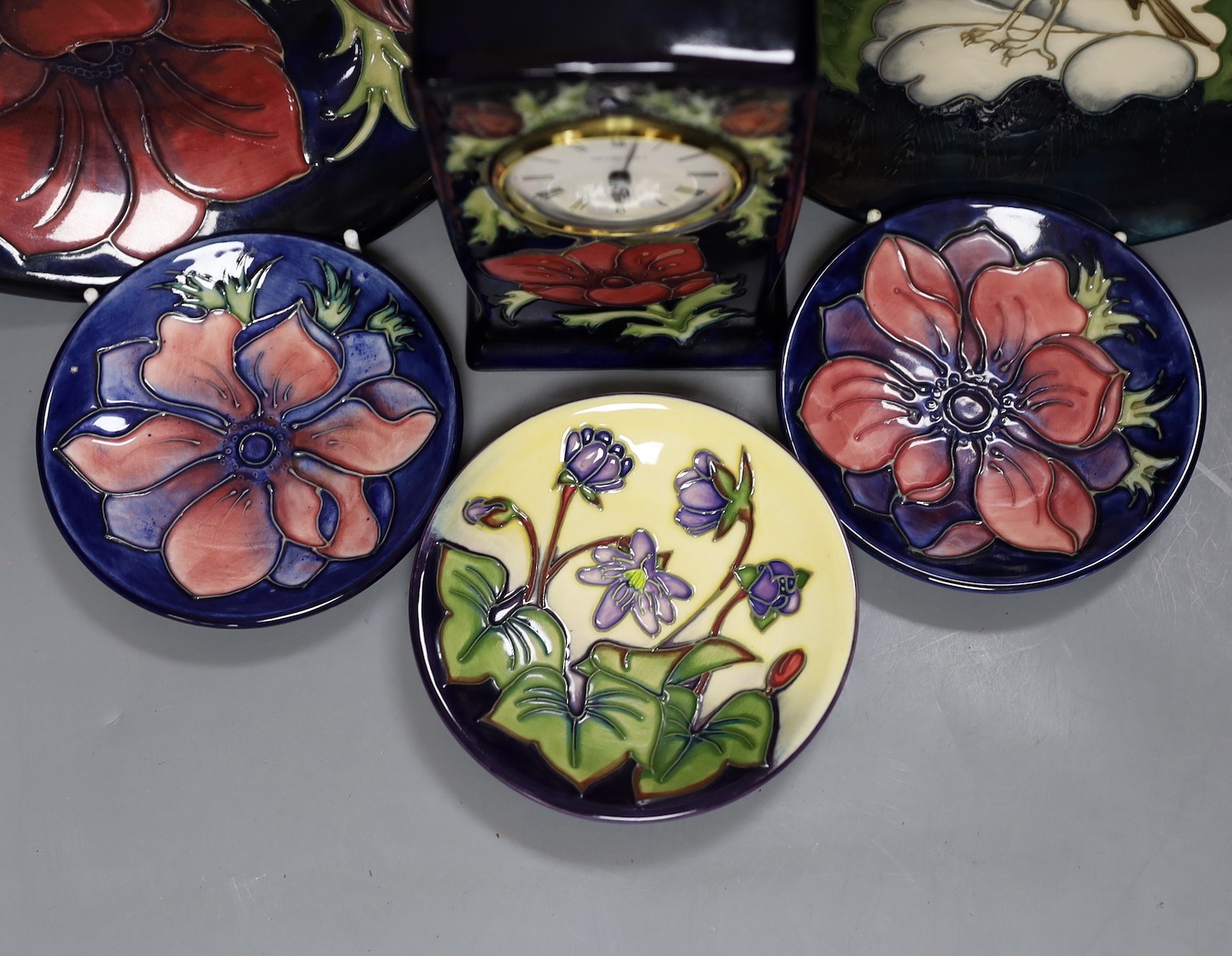 Five Moorcroft pottery dishes and a timepiece